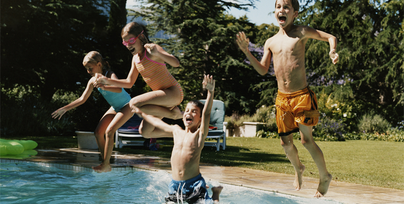 group of kids jumping into pool