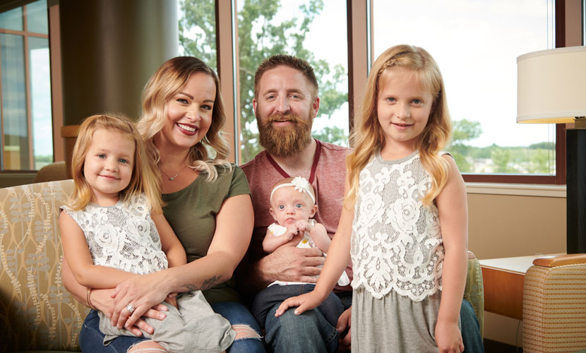 Family smiling on couch